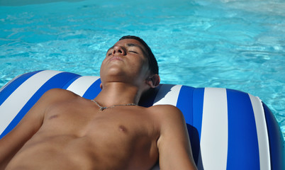 Adolescent qui se détend dans une piscine