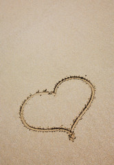 Fototapeta na wymiar heart on sea sand