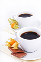 two cups of coffee with chocolate and winter cherry