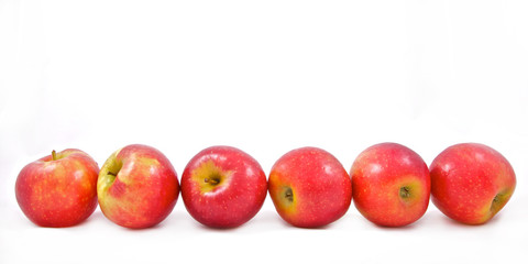 six red apples in a row isolated on white background