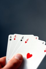 Obraz premium hand holding four aces