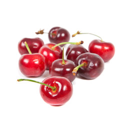 Fresh ripened red cherries over white background