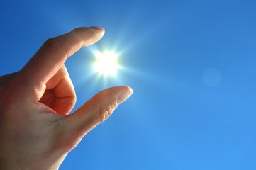 hand sun and blue sky