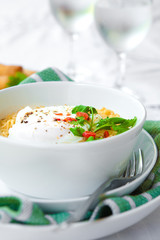 A bowl of spicy oriental noodles with poached egg