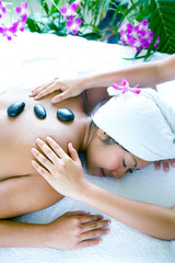 Obraz na płótnie Canvas Young woman enjoying a massage day at the spa