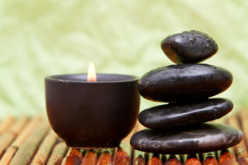 Fototapeta na wymiar Balanced pebbles and aromatherapy candle