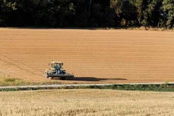Tractor on Dusty Field