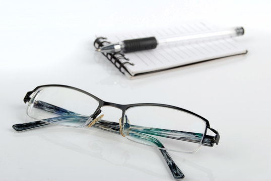 glasses,pen with notebook