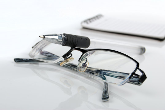glasses,pen with notebook