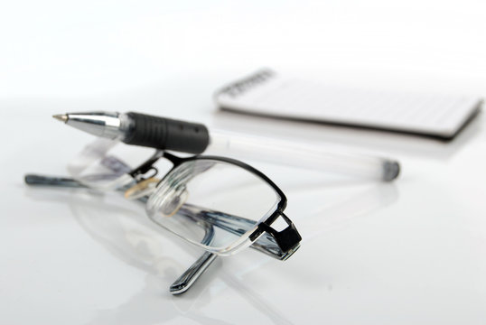 glasses,pen with notebook