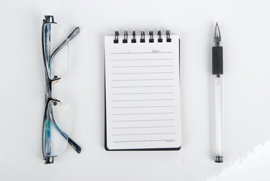 glasses,pen with notebook