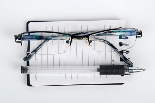 glasses,pen with notebook