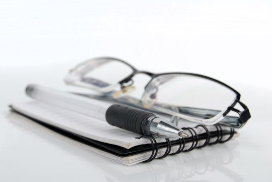 glasses,pen with notebook