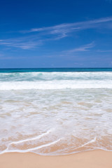 Fototapeta na wymiar Beautiful beach with crashing waves in the tropics
