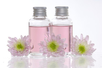 Reflection of spa bottles and daisies