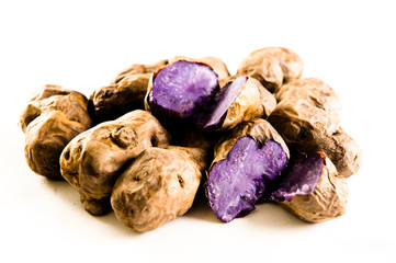 Purple potatoes on white