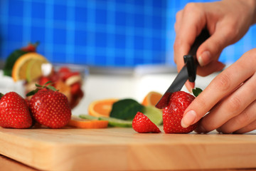 Female chopping strawberry.