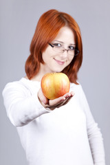 Girl with apple in hand. Studio shot.