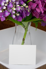 Flowers in a vase with blank card