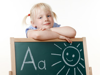 Cute blond girl is learning the ABC