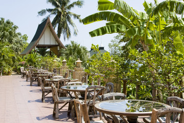 Table and chairs in empty cafe  at island Koh Chang , Thailand.