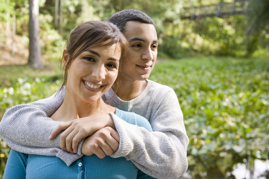 Portrait Of Hispanic Mother And Teen Son Outdoors
