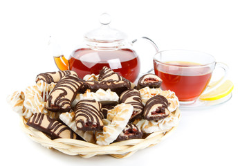 Teapot, cup of tea  with lemon and pastries