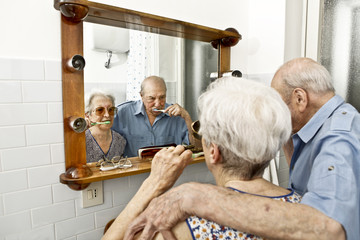 elderly couple washing teeth