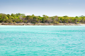 Cyan ocean before beach with sand