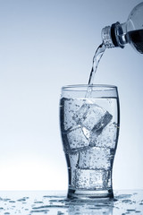 Cold purified water in the glass with bubbles