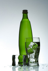 Cold purified water in the glass with bubbles and reflection on