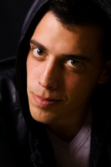 Portrait of a young casual man on black background