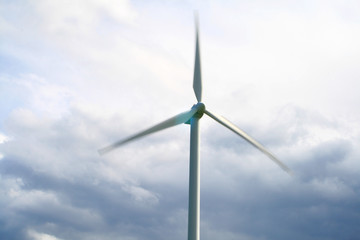 Fototapeta premium Wind turbines going fast giving power