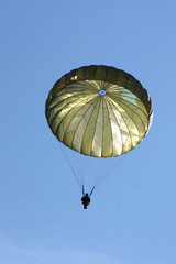 Paratrooper During a Military Drill with blu sky behind