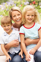 Fototapeta premium Mother And Children Relaxing In Garden