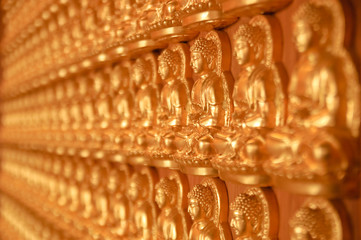 Wall of thousand buddha at a chinese temple in Thailand
