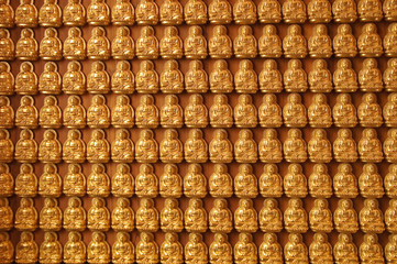 Decorated wall with thousand of small buddha images, Thailand.