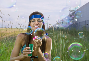 woman blows soap bubbles