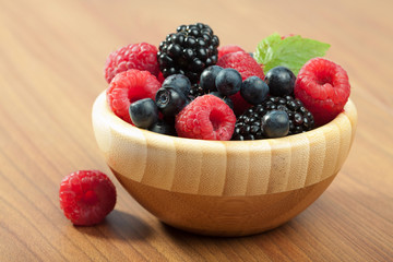 fresh berries in wood bowl