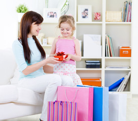 Woman and daughter with gift after shopping