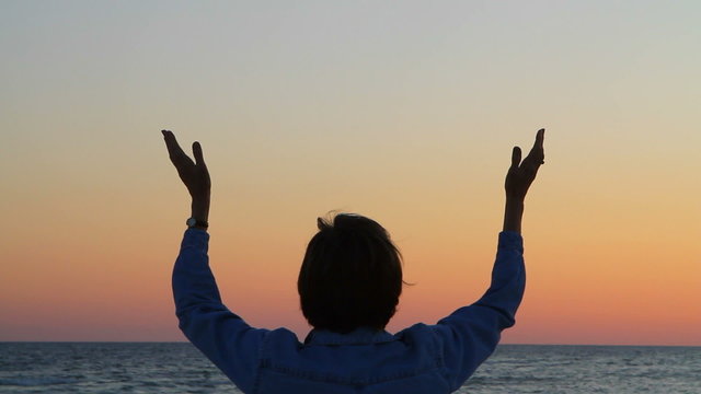 Woman's Hands Raised In Prayer