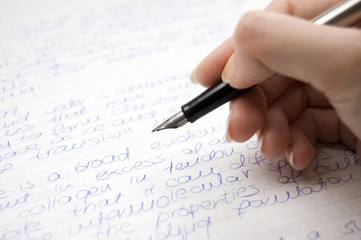 female hand holding pen, writing