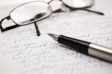 Pen and glasses on a notebook