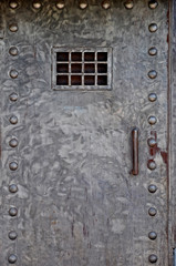 Metal door with a grate