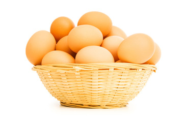 Brown eggs in the basket on white