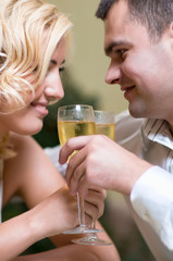 Cheerful young couple drinking champagne in a restaurant