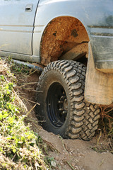 Fototapeta na wymiar 4x4 off-roader tyre stuck in rut