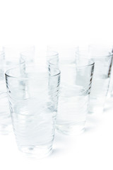 many glasses of clean water isolated on white