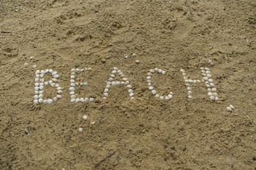 inscription beach from sea shell