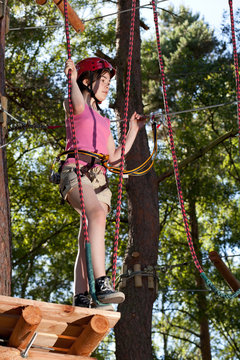 Girl climbing in adventure park
